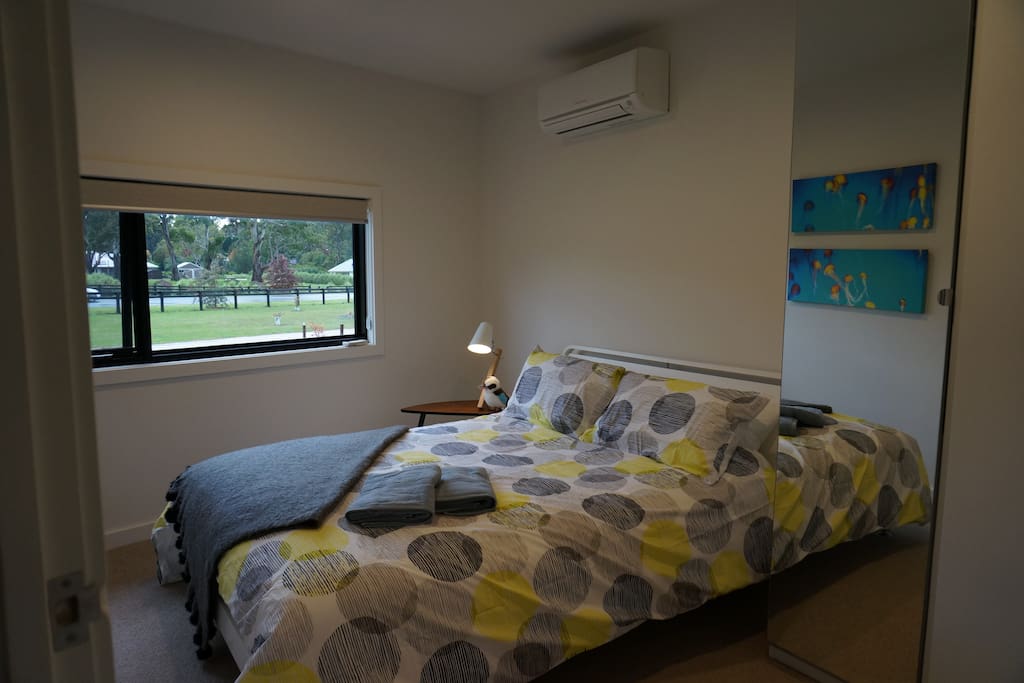 Bedroom with queen bed and views over the garden.