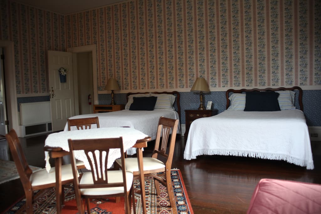 Two queen-sized beds, and a twin day bed, with room to play cards.