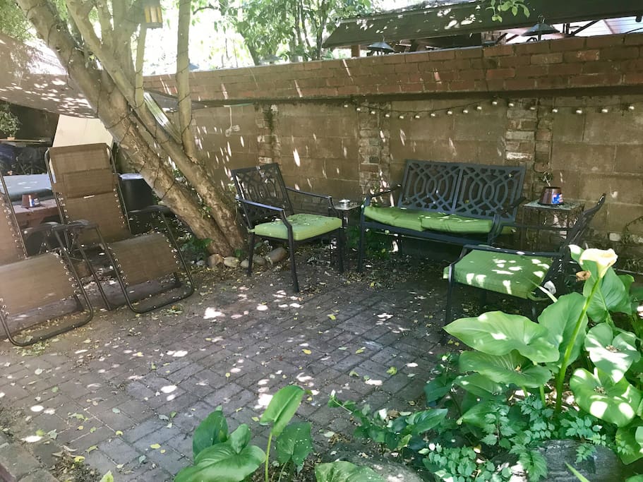 Shady patio with lots of seating just outside your front door!