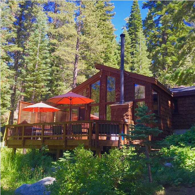 Exterior of the cabin with a large deck facing the creek.