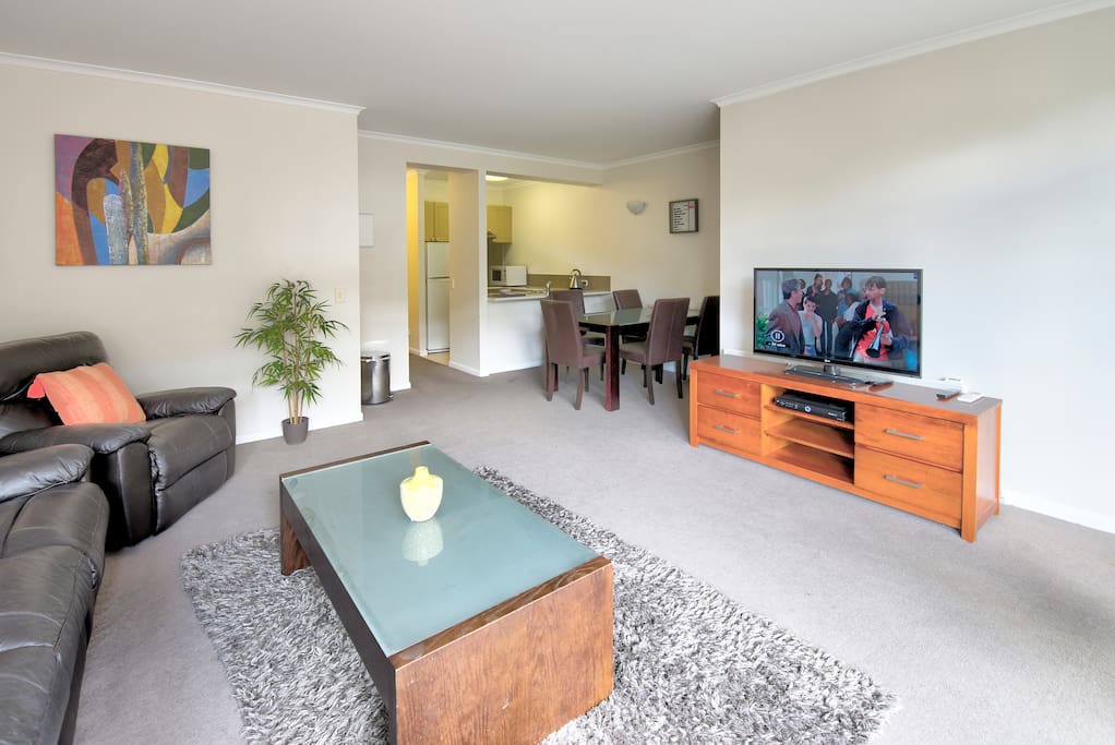 View of the lounge, dining area and kitchen. The television has cable (Foxtel Platinum)