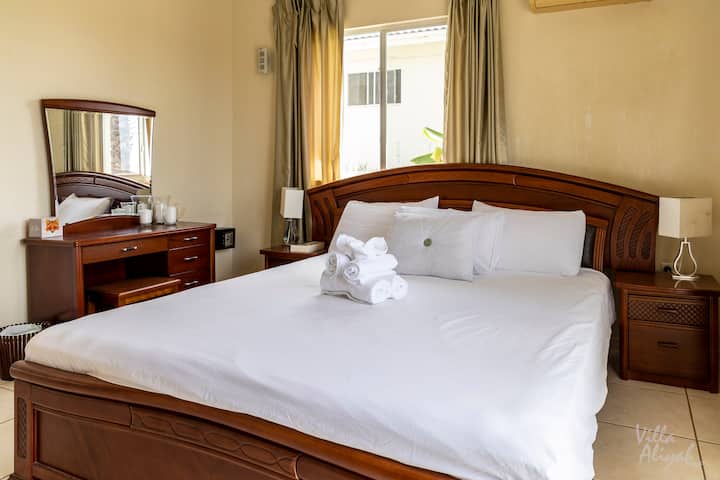 A king size bed in one of the upper level bedrooms.