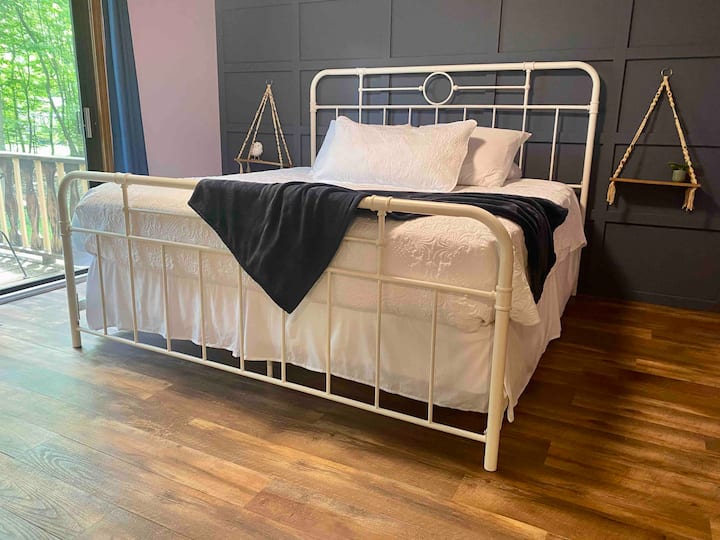 The main floor king bedroom has its own balcony that overlooks the wooded backyard.