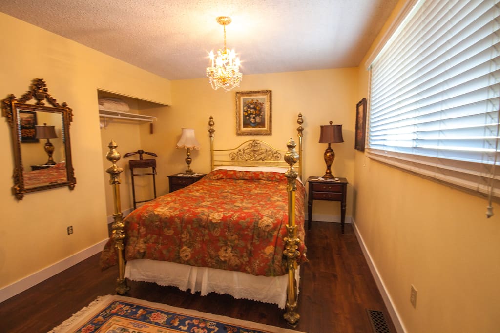 Bedroom C with a queen size bed and a private half bathroom on the main floor