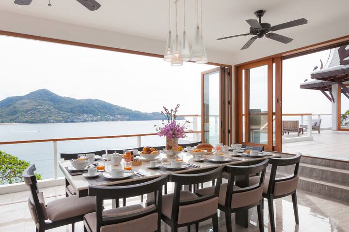 The dining area with foldable doors opening up onto the balcony
