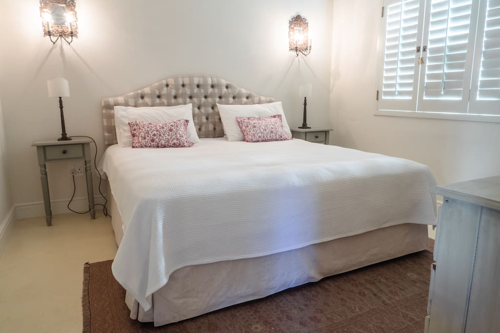 Comfortable king size bed with percale linen, feather or synthetic pillows
