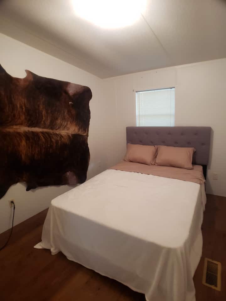 2nd bedroom  has a walk-in closet and views of the pine trees. Across from 2nd bathroom