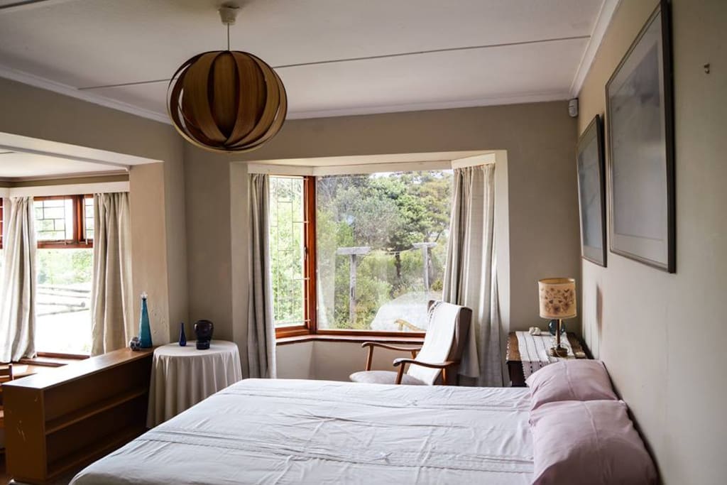 Main Bedroom with double bed. View over beautiful Fynbos Garden. Also have a study nook.
