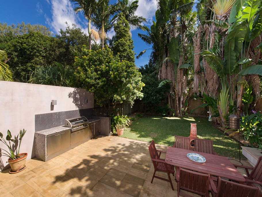 Lush, green outdoor living. Huge barbecue.