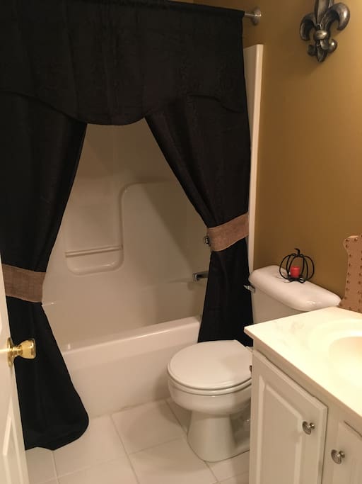 Guest bathroom located at end of hallway.
