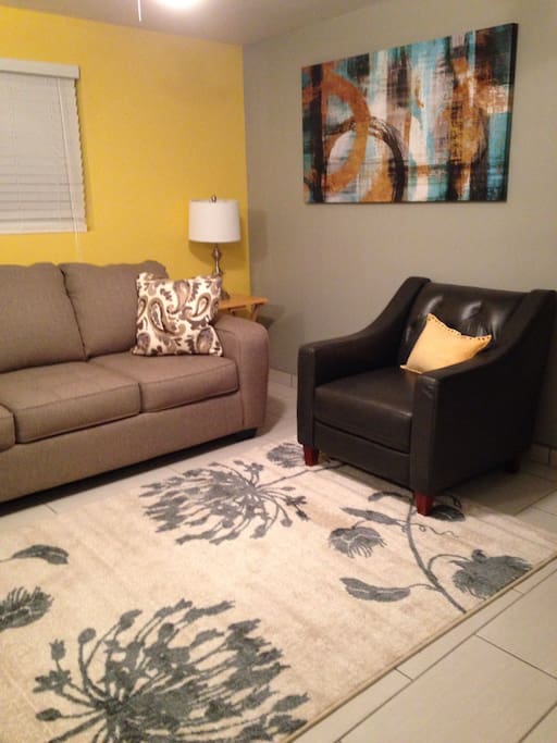Living room. Queen sleeper, 40 inch TV. Leather gray chair.
