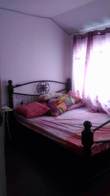 non-ircon room with a queen bed