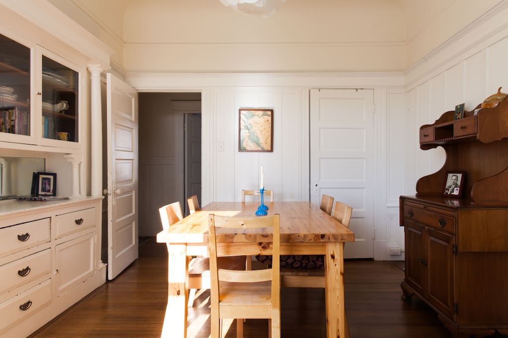 The sunny dining room seats six to eight and has a built-in hutch and view of hills.