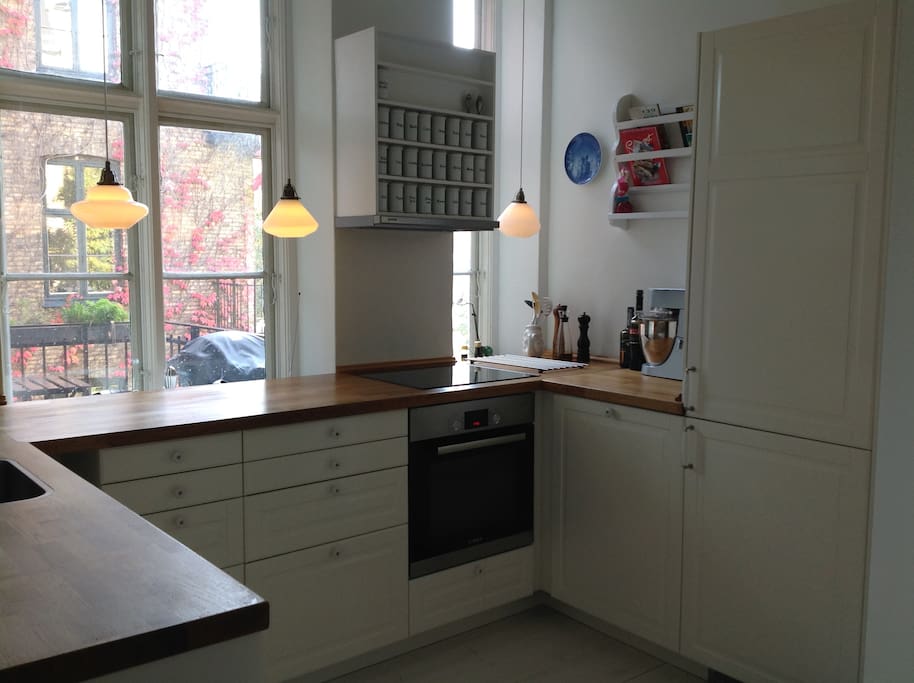 New kitchen with modern hob, oven, dish washer, microwave, refrigerator and freezer.