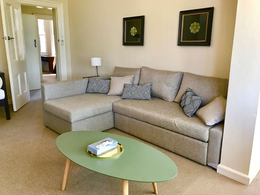 The lounge room has a large sofa which is also a pull out queen bed.