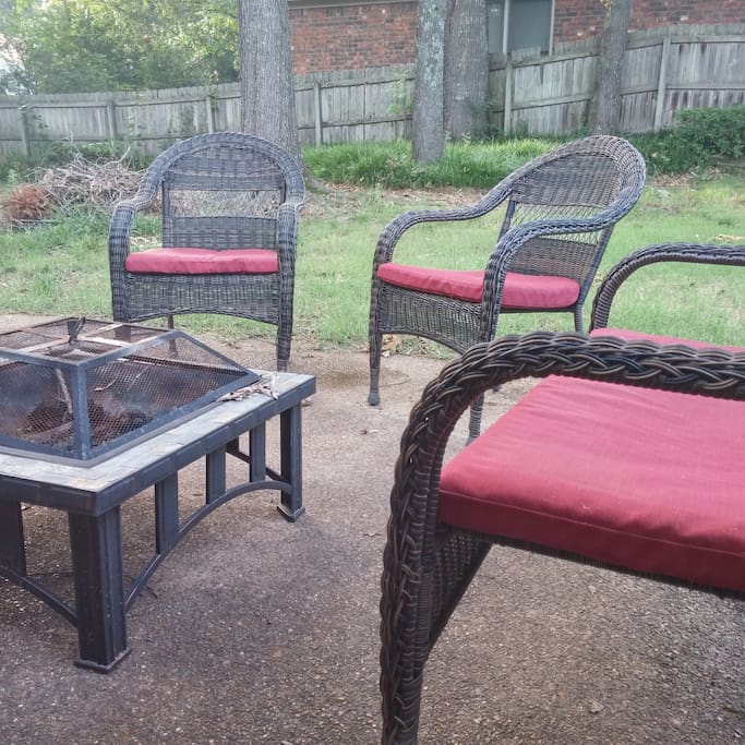 Back yard patio with wicker furniture and fire pit
