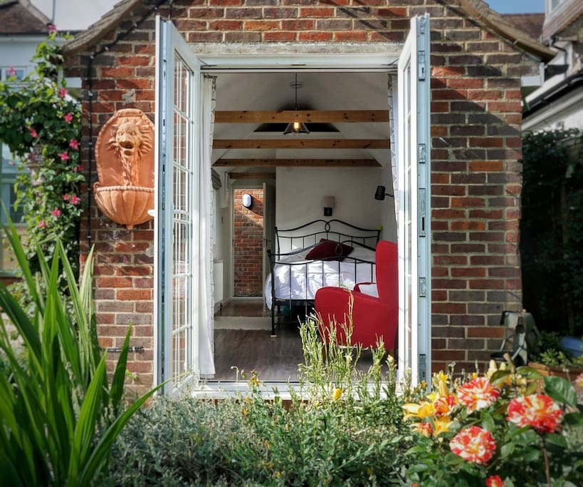 South-facing French doors opening to patio area and garden.