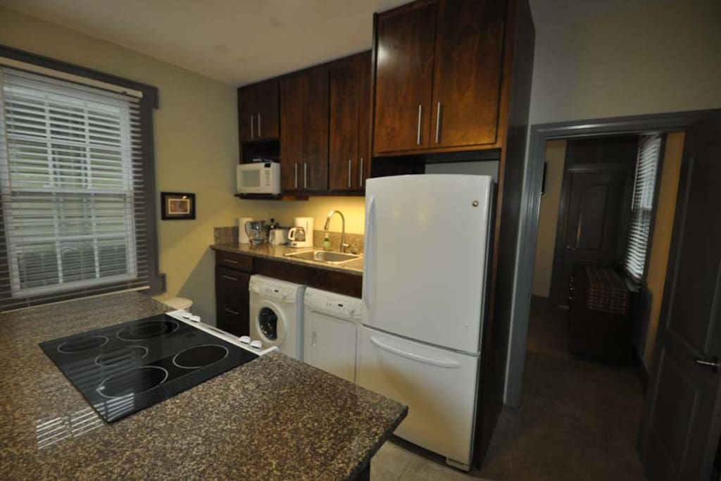 Full kitchen as part of living space with washer & dryer.