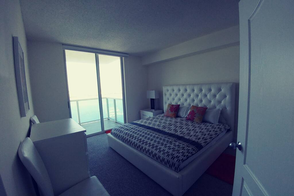 Master bedroom with a king size comfortable bed.