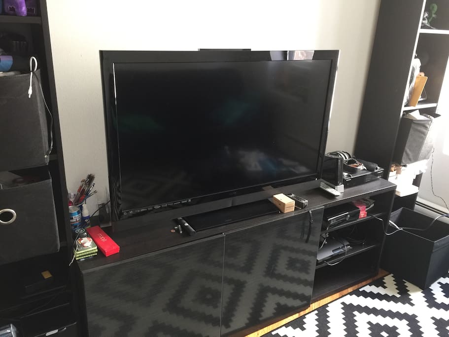 42" TV comes with Amazon Fire TV, Xbox 360, Wii, and PS3. Games are in the cabinets and you are welcome to play them.