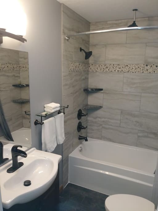 Bathroom with heated floors, bluetooth speaker, duel shower heads controlled independently and custom tile and granite throughout