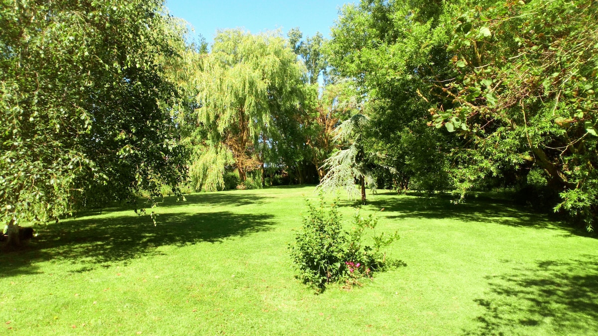 A spacious green park spans 6,000 m², featuring well-maintained grass and a variety of trees providing shade. The area offers a peaceful natural setting, ideal for relaxation and outdoor activities.
