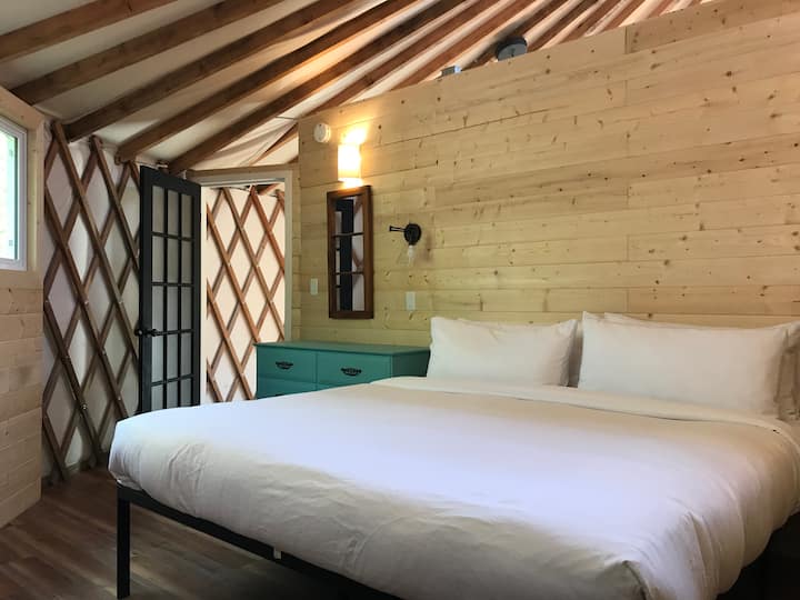 King size bed with bamboo bedding and a Canadian goose down duvet, sleeping in the yurt is extra cozy.