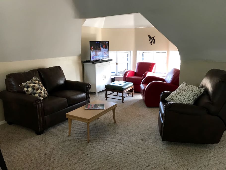 A 40" Samsung "smart" TV with Wifi, 2 barrel chairs, a recliner, and a loveseat-sleeper