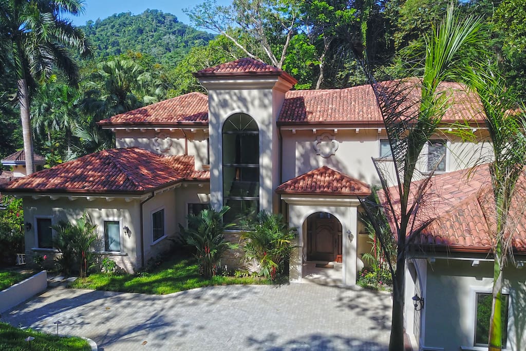 Casa Vista Paraiso, entrance and garage for 2 cars. Driveways in paver stone with golf cart parking and electric charging station.