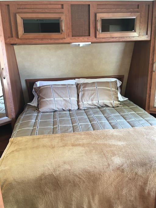 Queen size bed with closet space on each side.