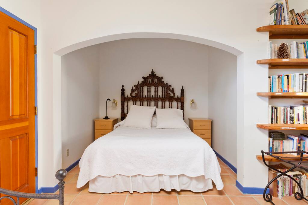 Comfortable queen-size bed in alcove with 100% cotton bedding.