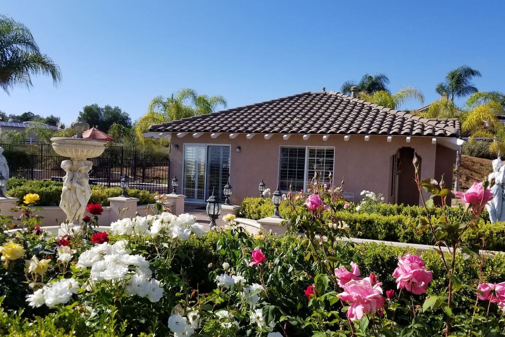 The guesthouse sits adjacent to a rose garden on one side and a private pool area on the other side.