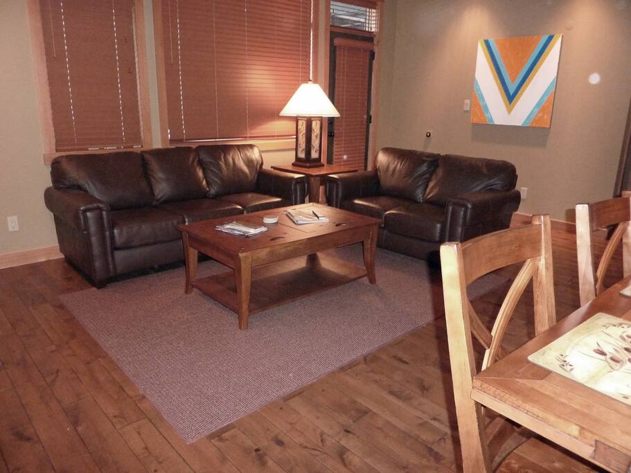 Den has leather sofa and love seat, mountain views and access to patio with large hot tub
