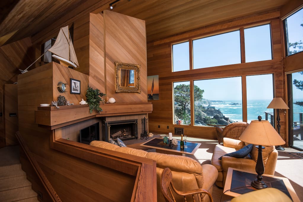 Living room with soaring ceilings, forever views, wood burning fireplace, 50" smart TV and game table.