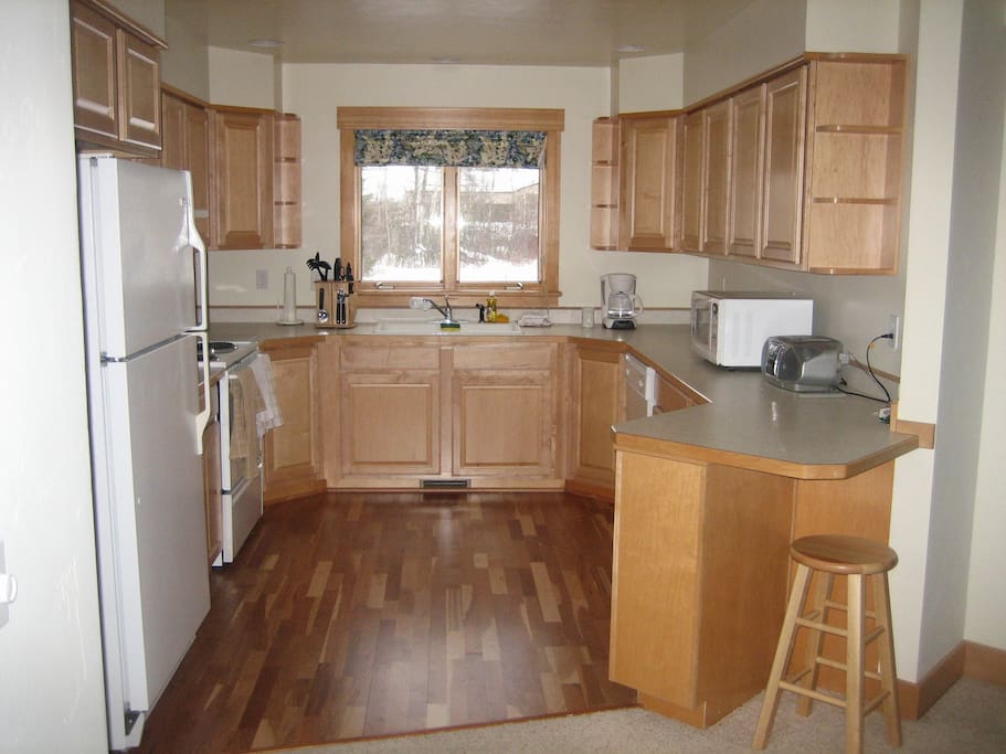 Full kitchen with all appliances and cooking utensils.