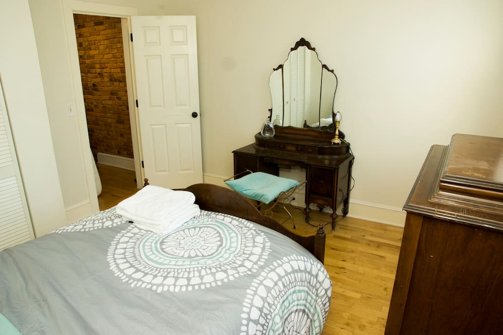 The room is fitted with antique hardwood furniture.
