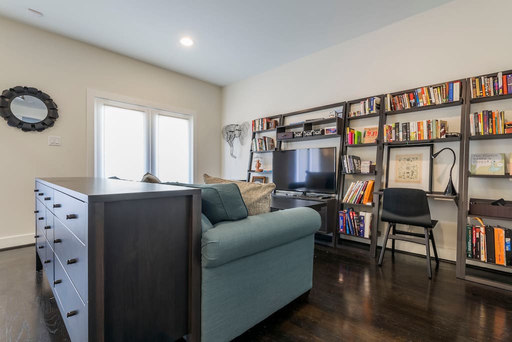 The first floor bedroom has a HD TV, a work-space, and lots of books to borrow.