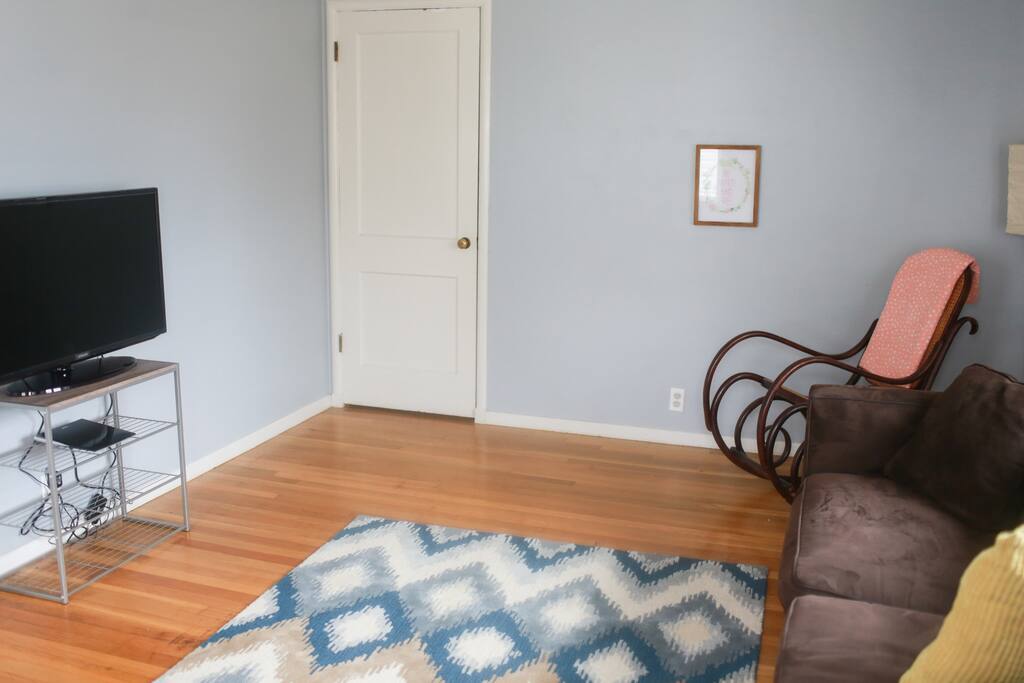 Extra closet space filled with blankets, pillows, toys & an ironing board.