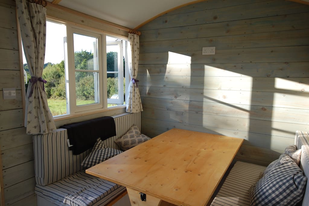 Inside family hut - table and seating to king size bed