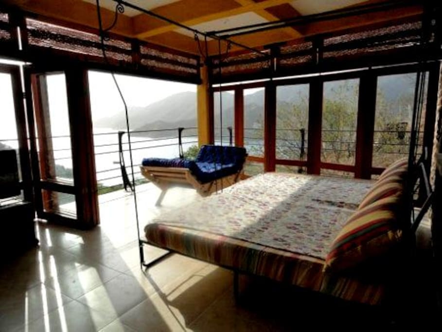Main room with ocean view and slide-open windows for fresh air