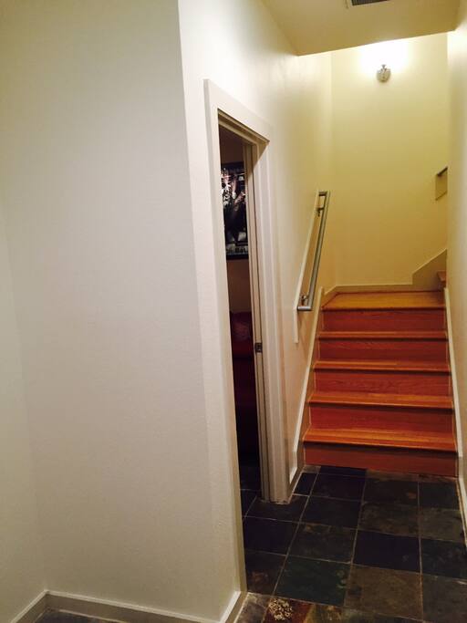 Entrance to the house. Bedroom is first door on the left. Stairs lead to kitchen/living area