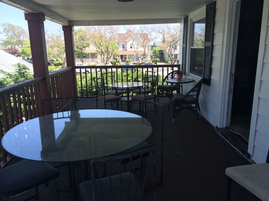 Huge porch with 3+ tables and lots of chairs