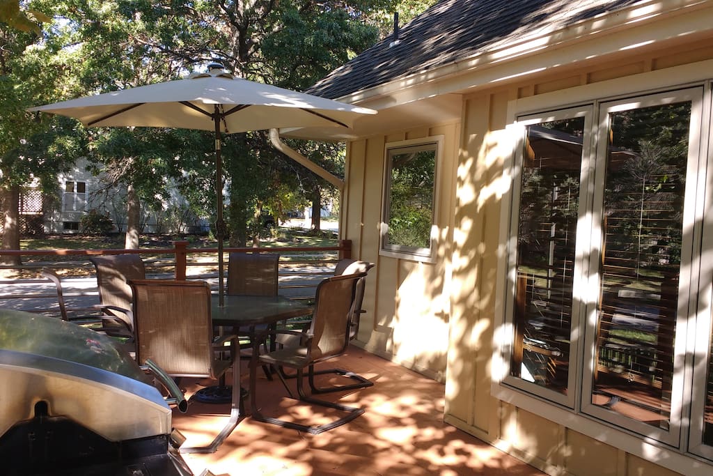 Shaded deck with grill and table with seating for six