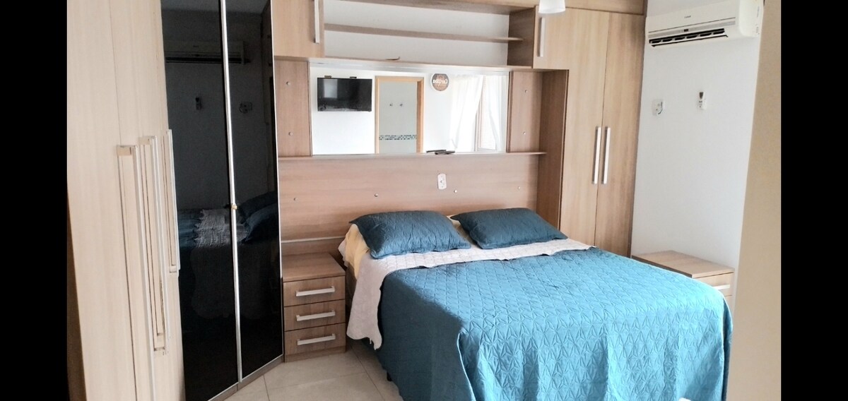 Master suite with 32-inch TV,  air conditioning, ceiling fan and balcony with protective screen 