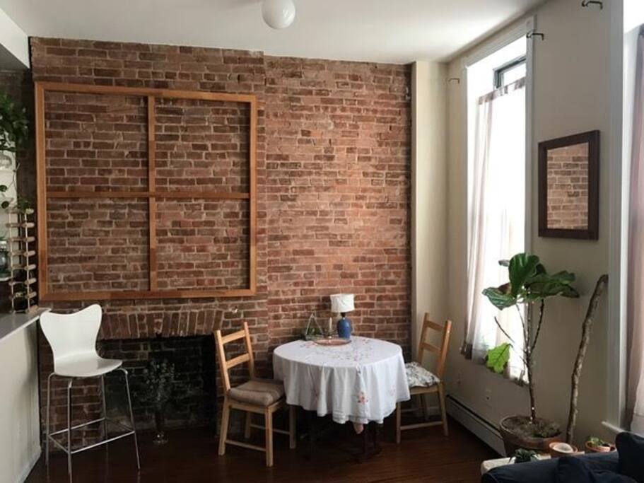 Eucalyptus will always be nestled in the old fireplace. This photo shows you the openness of the apartment as the kitchen looks over the living room