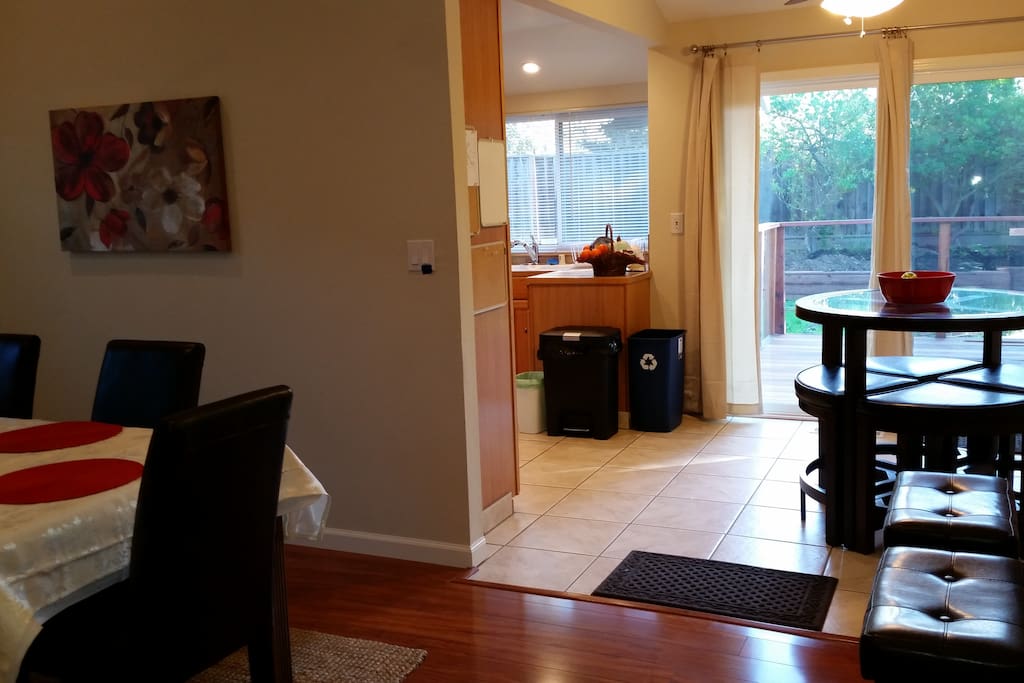 Dining room connected to breakfast area over looking the backyard and redwood trees; extra seating nearby