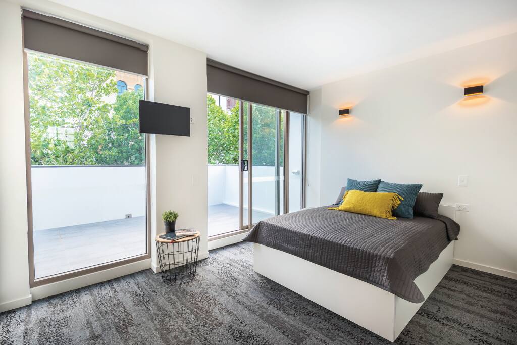 Bedroom with spacious balcony overlooking Foveaux St