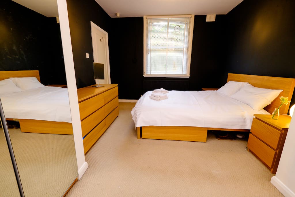 Double bed in spacious bedroom with en suite bathroom and plenty of storage space