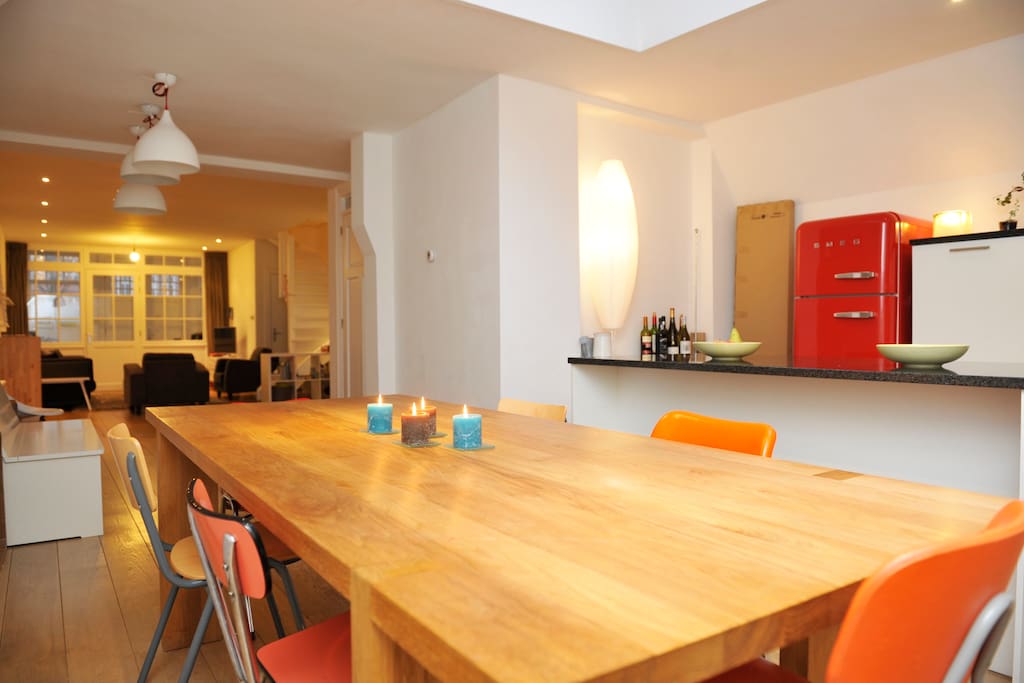 Solid wood dinner table seats 8 comfortably next to spacious chef's kitchen