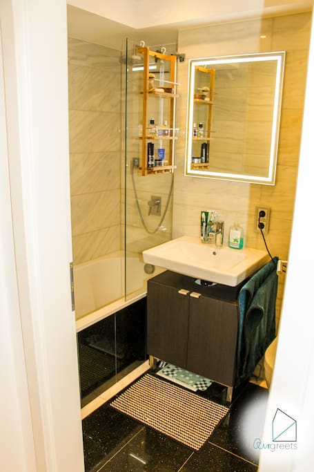 The bathroom has a tub with an integrated shower.